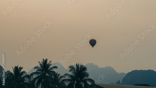 Hot Air Balloon over Vang Vieng Laos at sunset. A beautiful city on the river with huge rising mountains and slow flowing river.