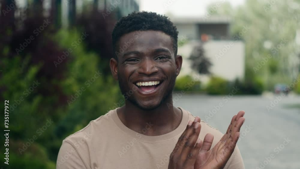 Happy smiling African American man smile applauding looking at camera outdoors in city park cheerful successful supporting ethnic guy male supporter applaud clapping hands support applause cheering Happy smiling African American man smile applauding looking at camera outdoors in city park cheerful successful supporting ethnic guy male supporter applaud clapping hands support applause cheering