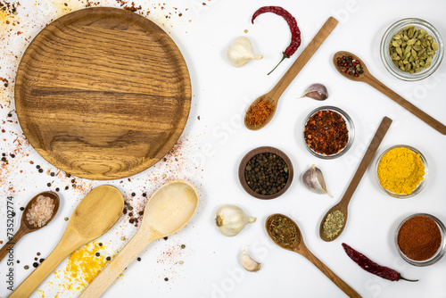 Spices in wooden dishes isolated on white background. Free space.