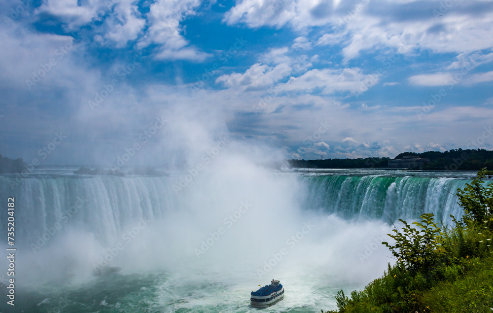 Peasure boat with tourists near Niagara Falls Peasure boat with tourists near Niagara Falls