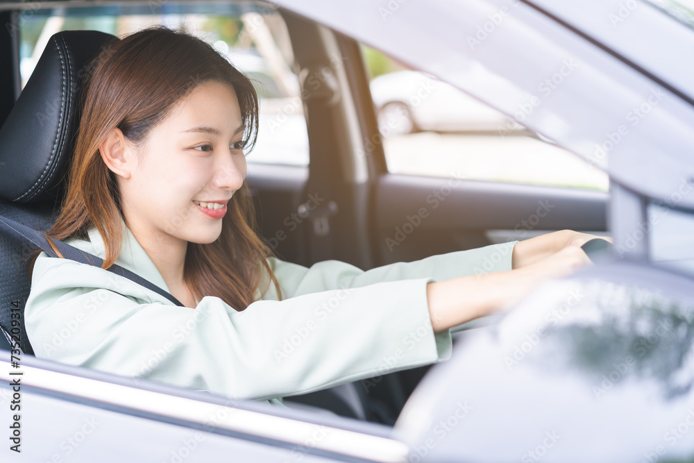 Transport, happy smile brunette hair asian young woman hand holding steering wheel driving car, vehicle for travel trip, sits on driver seat, female with fasten safety seat belt before traveling.