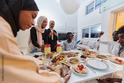 In the sacred month of Ramadan  a Muslim family joyously comes together around a table  eagerly awaiting the communal iftar  engaging in the preparation of a shared meal  and uniting in anticipation