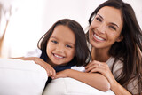 Happy mother, portrait and hug with child on sofa for love, bonding or care together at home. Face of mom, parent and little girl, daughter or kid smile in living room for family weekend or support