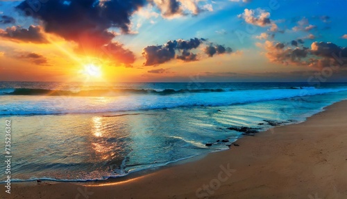 Beautiful landscape with sea sunset on beach. Bright orange sun and blue sky