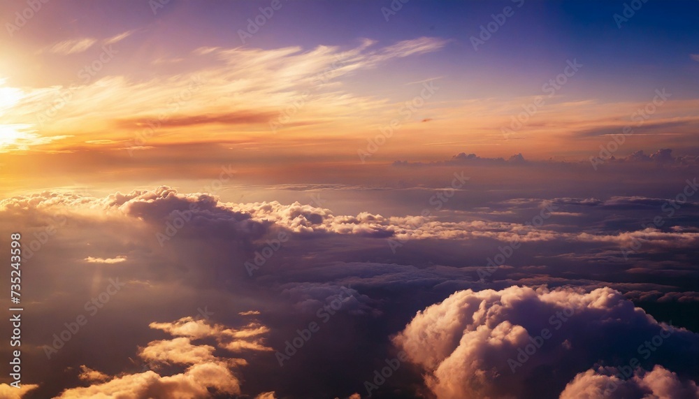 Beautiful aerial view above clouds at sunset. Cloudscape with blue sky.