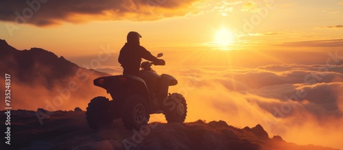 Adventurous person riding a thrilling quad bike through rugged terrain photo