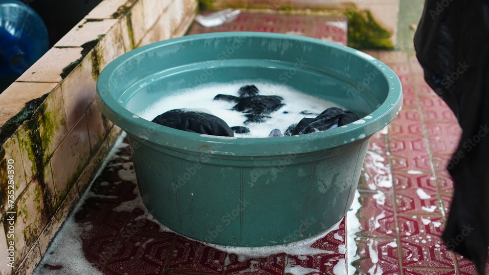 a bucket of water and dirty clothes a bucket of water and dirty clothes