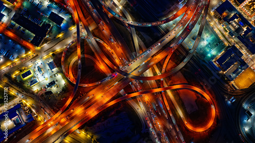 Bright illumination of roads in the downtown of Dallas, Texas, USA. Top view on the transport moving by the highways at night. photo