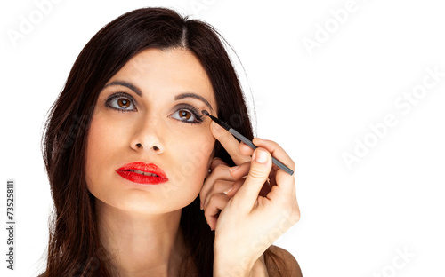 Close-up of a young woman applying black eyeliner  isolated on a white background