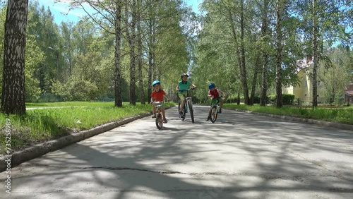 Wallpaper Mural Kids riding bicycles in the park. Healthy outdoor activity for young Boys. Happy children riding bikes wearing a helmets having fun on a bikes on sunny day. Torontodigital.ca