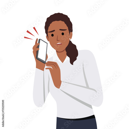 Shocked young woman talking on the smart phone or mobile phone scared in shock with a surprise face. Amazed frowning female calling