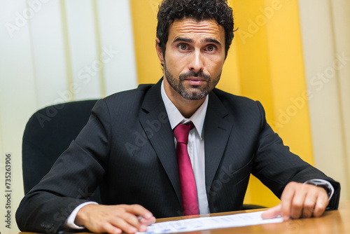 Professional male with a serious expression in a business meetin