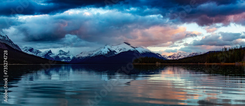 Glacier lake in Canadian Mountain Landscape. Dramatic Sunset. Maligne Lake, Jasper, Alberta, Canada.