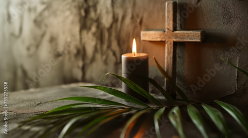 Wooden cross, candle and palm leaves photo
