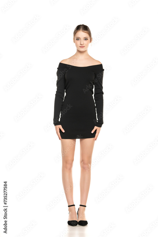 Summer Chic: Full-Length Portrait of a Young Woman Posing in a Short Dress and Sandals on White Background Summer Chic: Full-Length Portrait of a Young Woman Posing in a Short Dress and Sandals on White Background