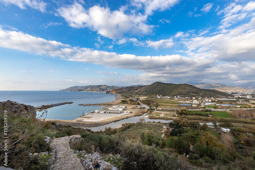 Panoramic view of the countryside and the Mediterranean coast, view from the mountain to a landscape with clouds and sea. Panoramic view of the countryside and the Mediterranean coast, view from the mountain to a landscape with clouds and sea.