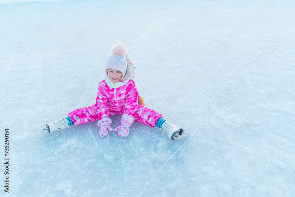 girl in pink overalls and pink hat skating on street rink girl in pink overalls and pink hat skating on street rink