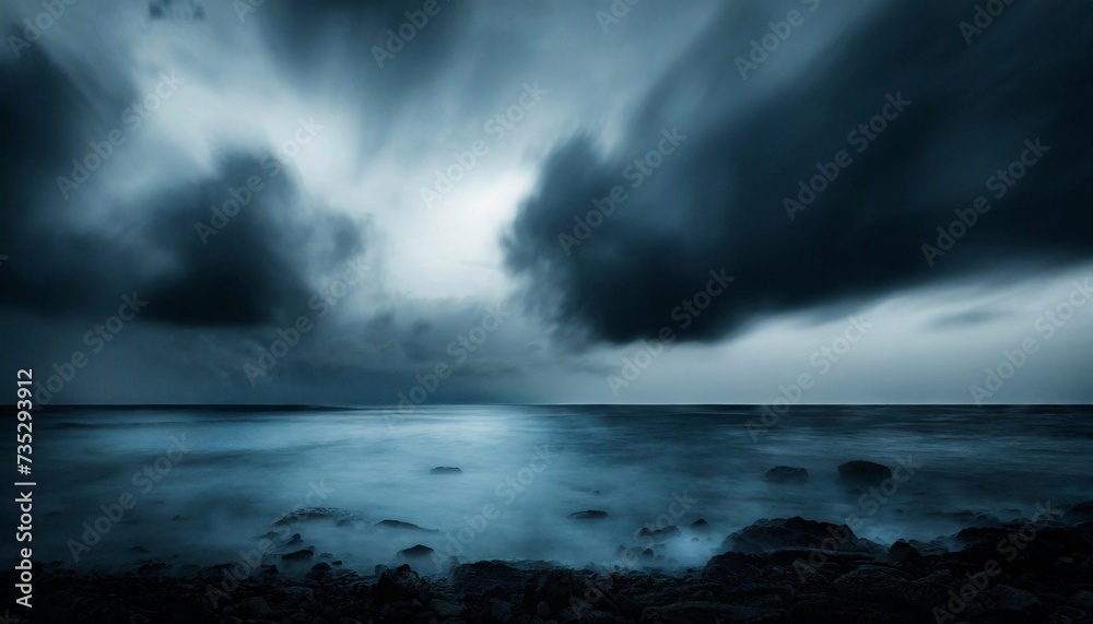 Seascape with dark blue sky and dramatic clouds. Night ocean. Gloomy weather.