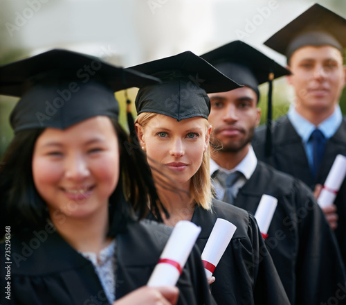 Portrait, graduation and woman in line with friends at college or university for ceremony of achievement. Education, certificate and scholarship with group of young graduate people outdoor on campus
