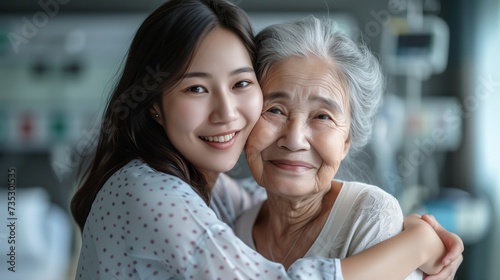 Elderly asian sick woman embracing her adult daughter in a hospital