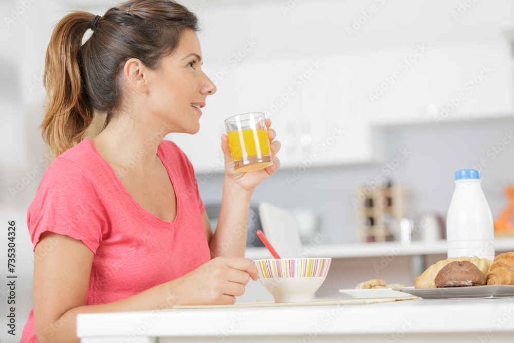 smiling pretty woman holding glass of orange juice smiling pretty woman holding glass of orange juice