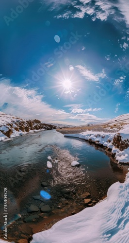the sun shines brightly over a small lake in the middle of a snow - covered landscape with rocks and ice.