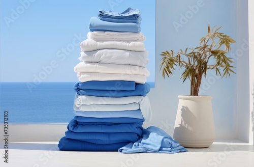 a stack of laundry stacked on a white table