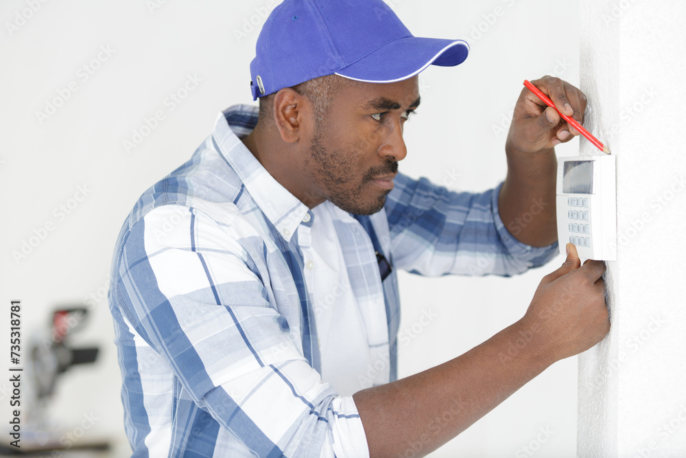 a man installing security equipment a man installing security equipment