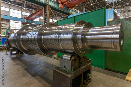 Shaft of big steam turbine in a factory workshop. photo
