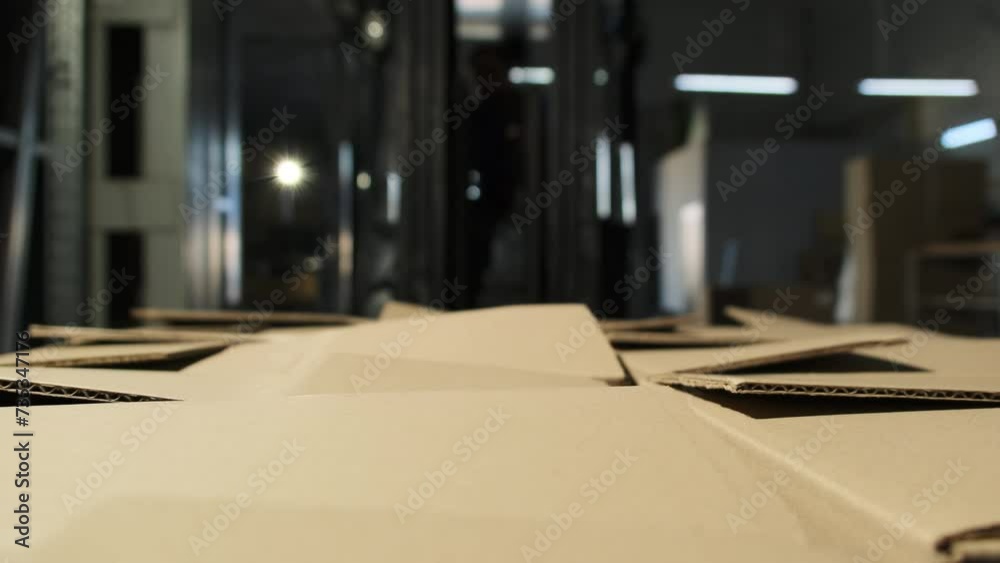 Forklift approaches boxes for lifting in storehouse. Maneuvers of ...