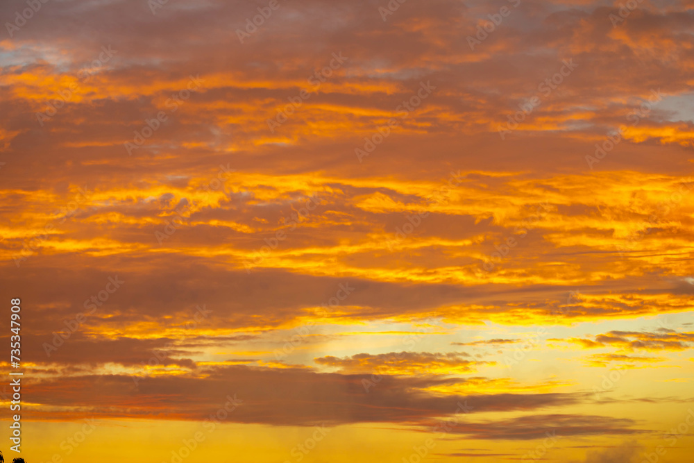 Beautiful idyllic sky at dawn with strong yellow and orange colors