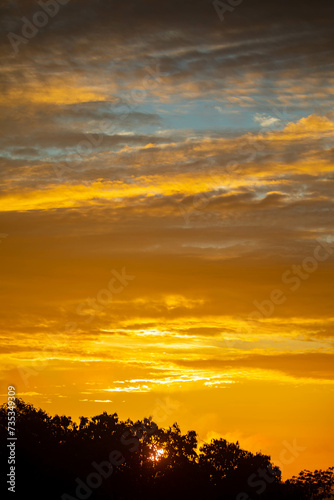 Beautiful idyllic sky at dawn with strong yellow and orange colors