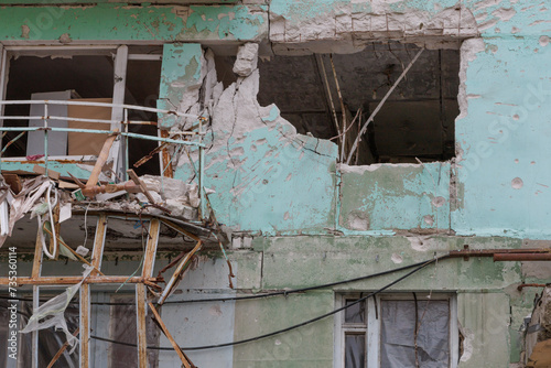 Closeup view of ruined facade of house. photo