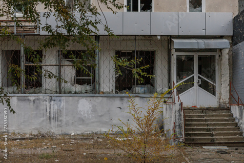 Closeup view of ruined facade of house. photo