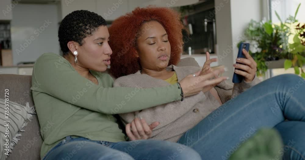 Lesbian Couple on Sofa Looking at Nail Polish Lesbian Couple on Sofa Looking at Nail Polish