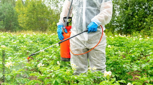 Plant protection against pests and diseases, A man in a white protective suit treats plants with a spray bottle.