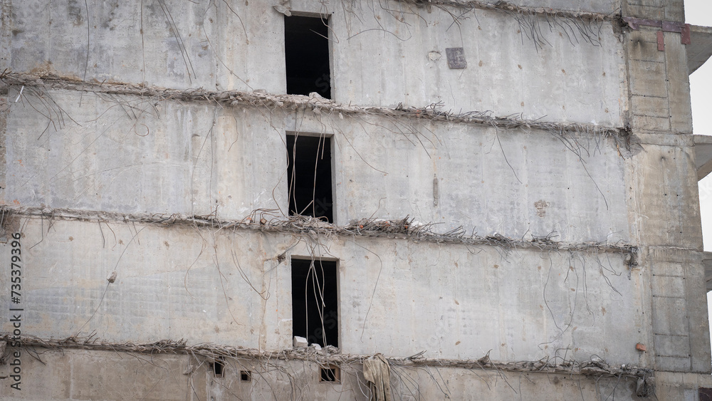 Partially demolished building close-up, bankruptcy of construction firms, deceived equity holders of shared construction, selective focus tinted image. Partially demolished building close-up, bankruptcy of construction firms, deceived equity holders of shared construction, selective focus tinted image.