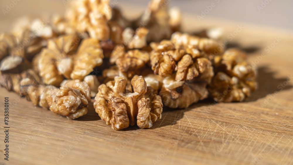 Peeled walnut kernels close-up on wooden background, Selective focus, tinted image. Peeled walnut kernels close-up on wooden background, Selective focus, tinted image.