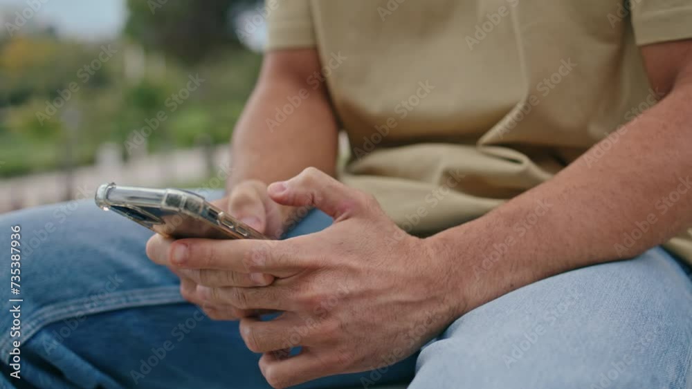 Man hands texting mobile phone outdoors close up. Unknown guy typing message Man hands texting mobile phone outdoors close up. Unknown guy typing message