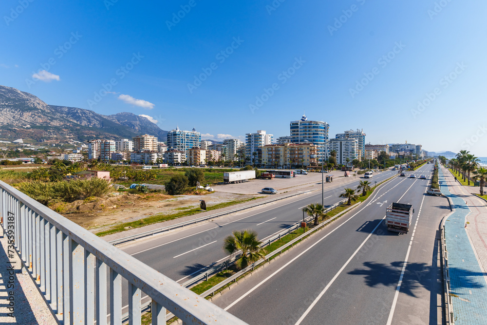 View of a Main Highway with Cars moving both ways in a Touristic City near high buildings