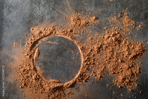 Cocoa powder on dark tile surface

