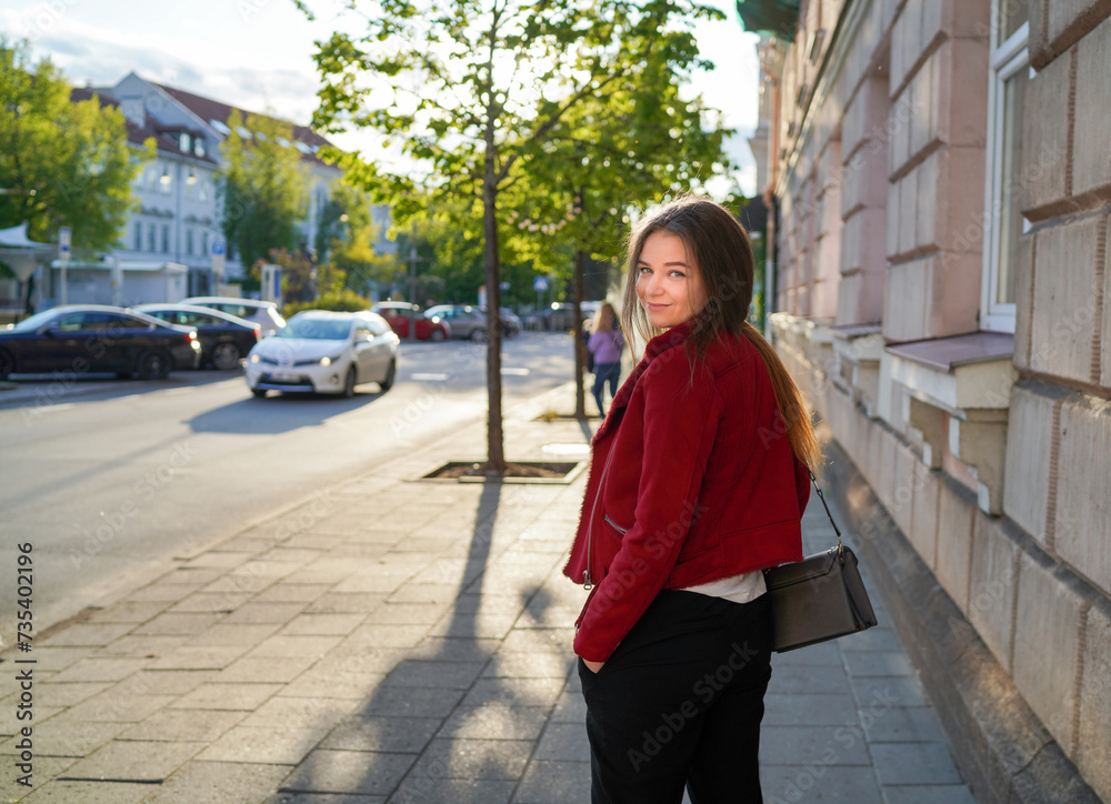 Beautiful Lithuanian Girl is Walking in Downtown of Vilnius, Capital of Lithuania. Sunlight, Happy Face. Beautiful Lithuanian Girl is Walking in Downtown of Vilnius, Capital of Lithuania. Sunlight, Happy Face.