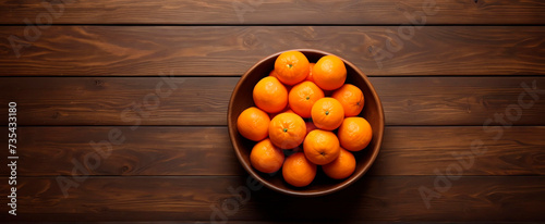 Fresh juicy clementine tangerines on a wooden table, view with copy space.