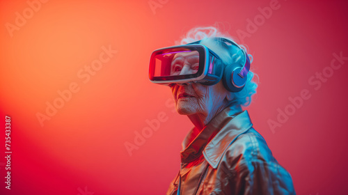 Funny portrait of an elderly grandmother wearing a VR headset on her head, dressed in a colorful modern suit, standing in front of a colorful wall.