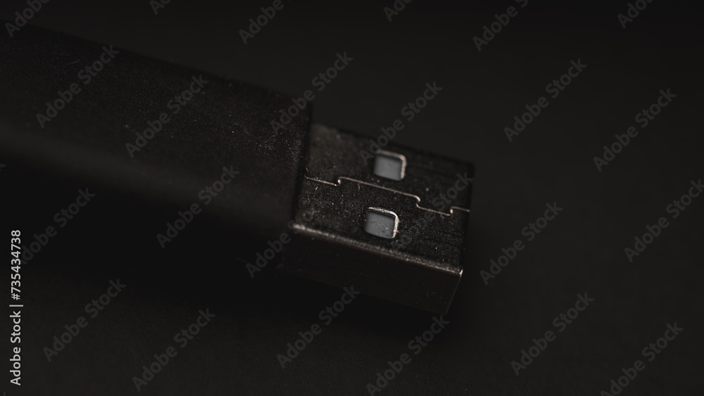 A sharply focused photograph captures a USB cable against a clean black background. A sharply focused photograph captures a USB cable against a clean black background.
