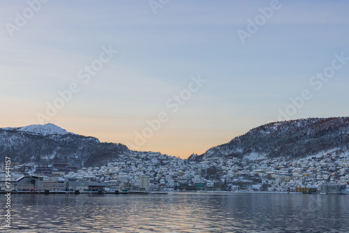 Obraz na płótnie South part of bay of Bergen in early morning of winter. Sun slowly rising behind the mountains revealing suburbs of Laksevåg and Damsgard w salonie