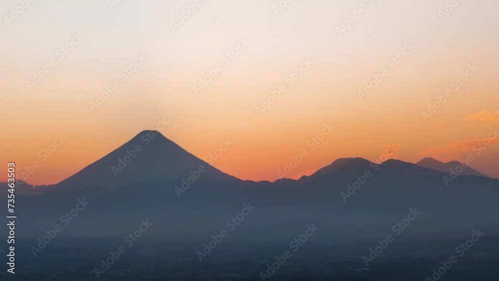 Aerial shot of sunset on a summer evening in Guatemala City with the volcano in the background. Aerial shot of sunset on a summer evening in Guatemala City with the volcano in the background.