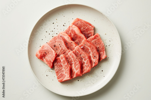 Japanese Wagyu beef on the white plate on the white table flat lay