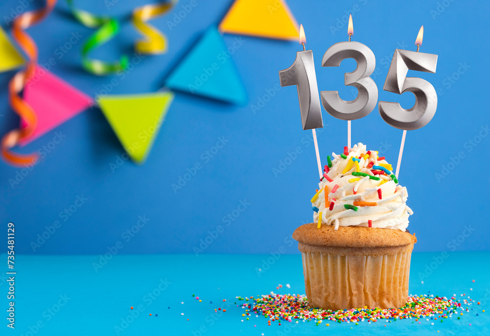 Birthday cupcake with candle number 135 - Blue background