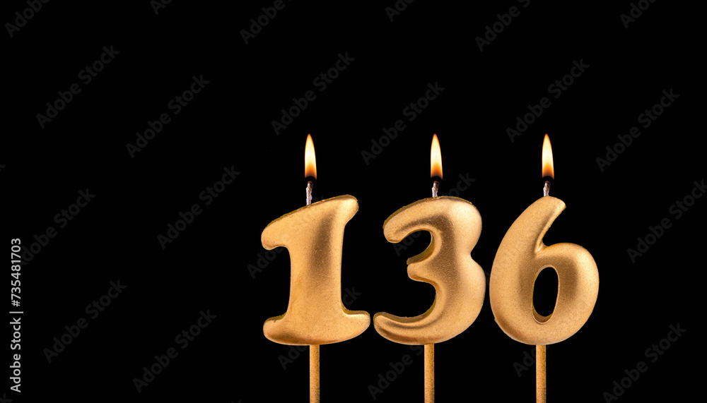 Golden candle 136 with flame - Birthday card on dark luxury background Golden candle 136 with flame - Birthday card on dark luxury background